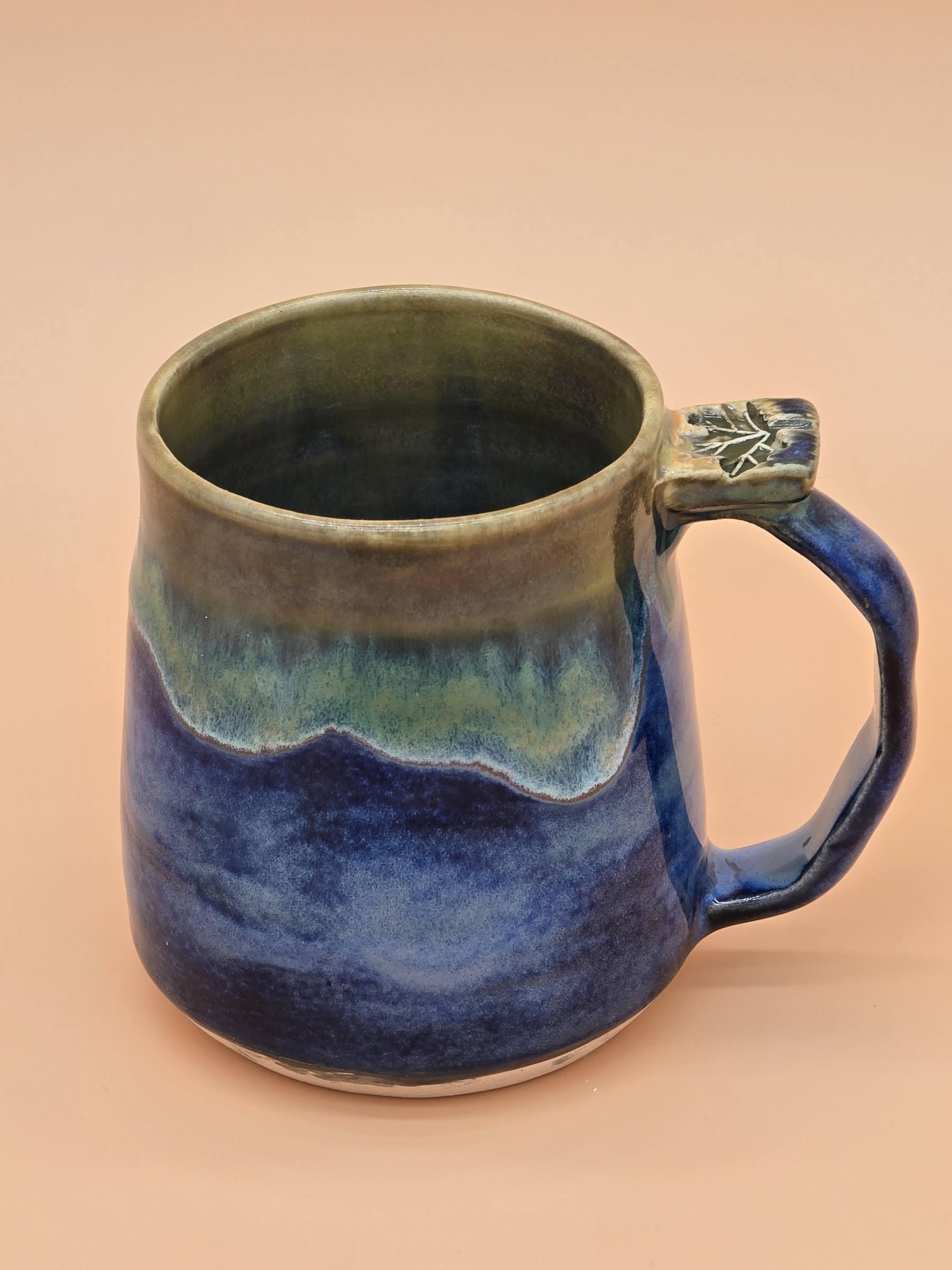 Handmade white clay beach mug with leaf detail by Clay Therapy